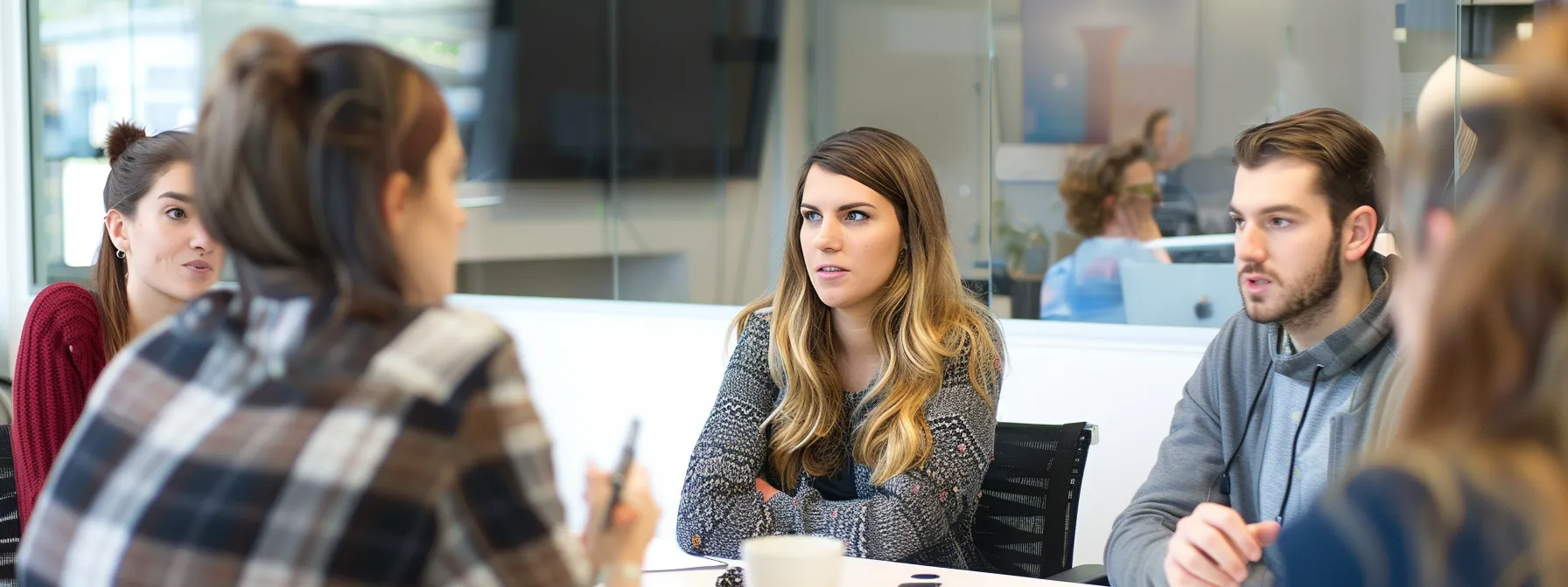 a focused interim cfo surrounded by vibrant, innovative startup founders discussing strategic fundraising plans.