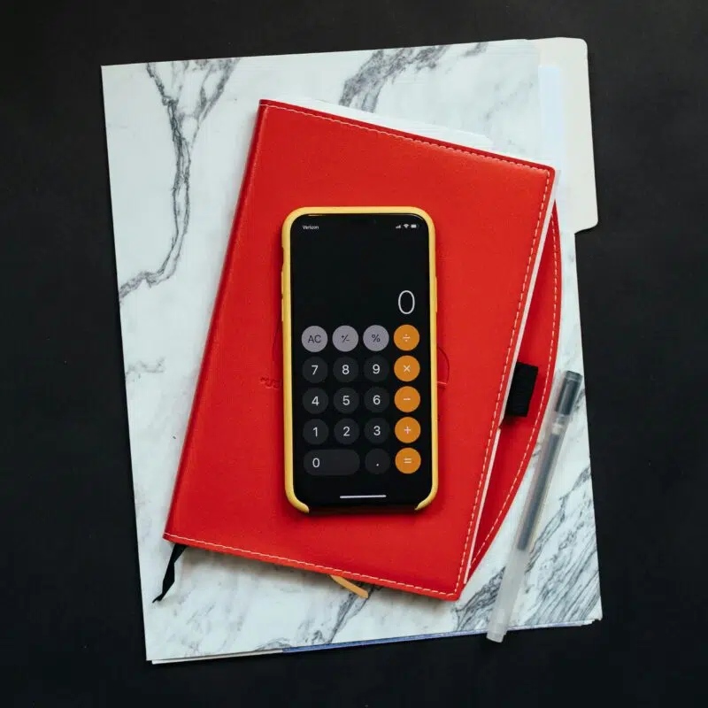 a calculator on a stack of books