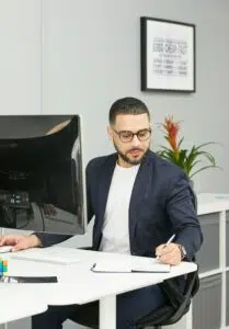 A financial consultant evaluates reports at a modern workstation, illustrating how businesses measure ROI from strategic financial leadership consulting in 2025.