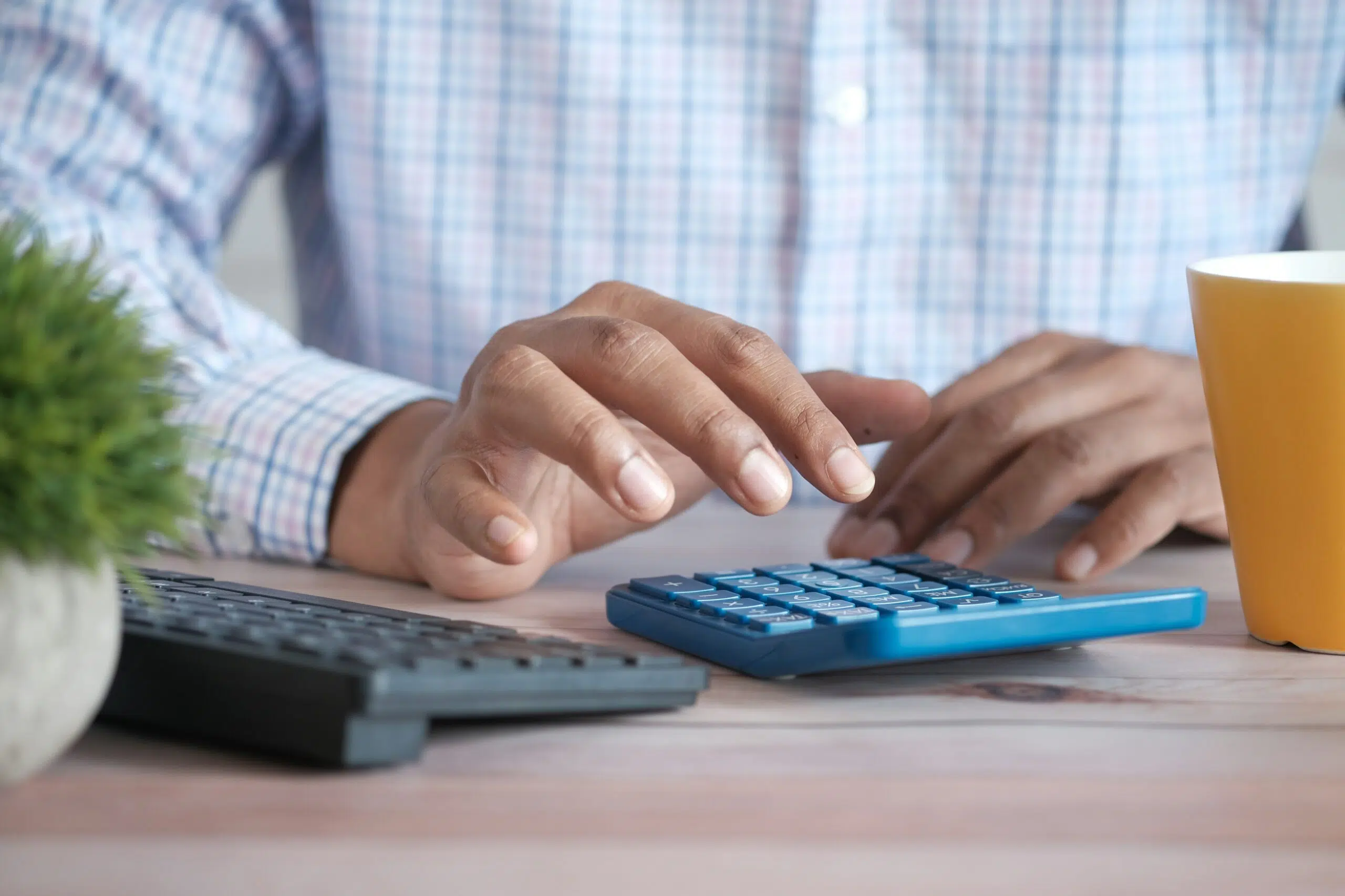 a person calculating finances on a calculator