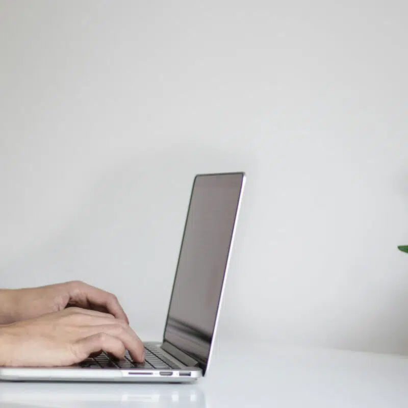 a person typing on a laptop