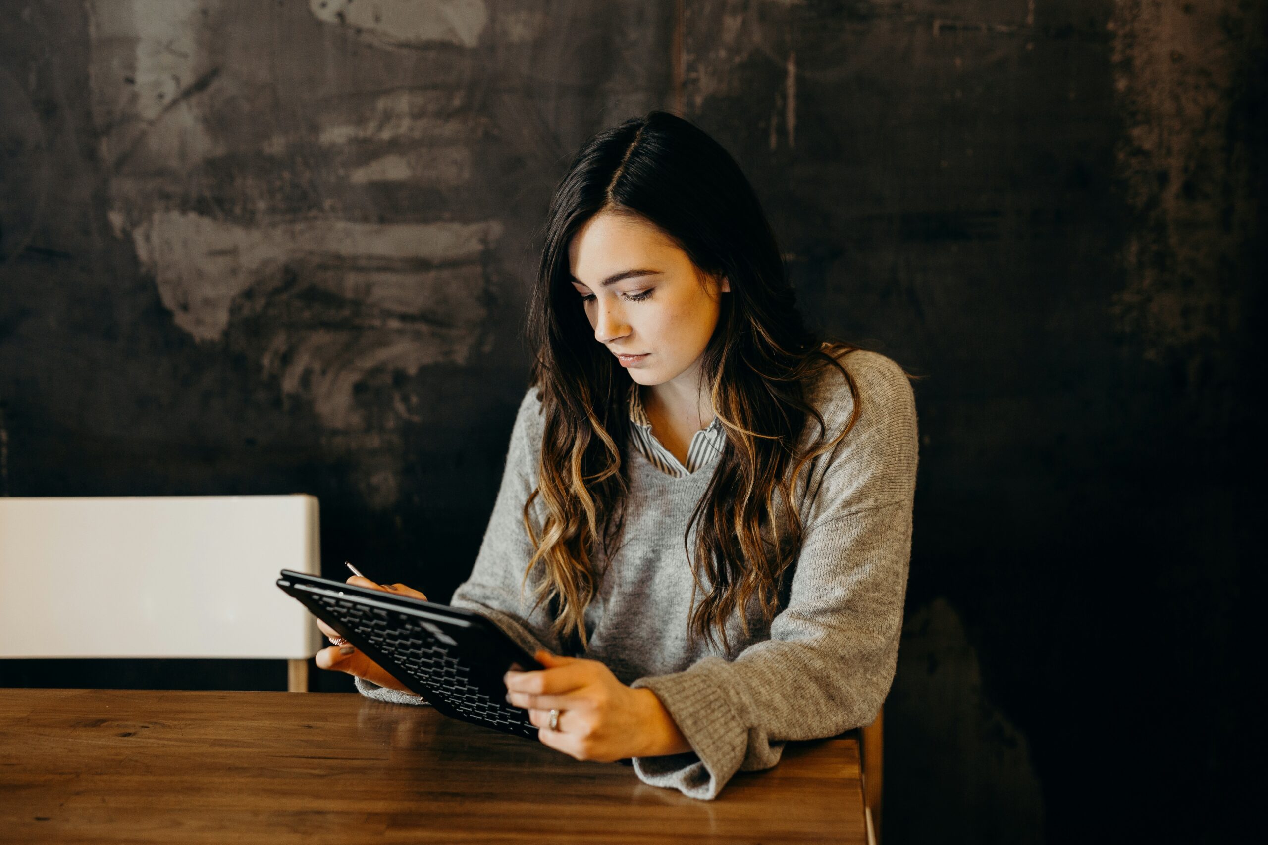 a finance expert working on her ipad | Cohesion a finance expert working on her ipad
