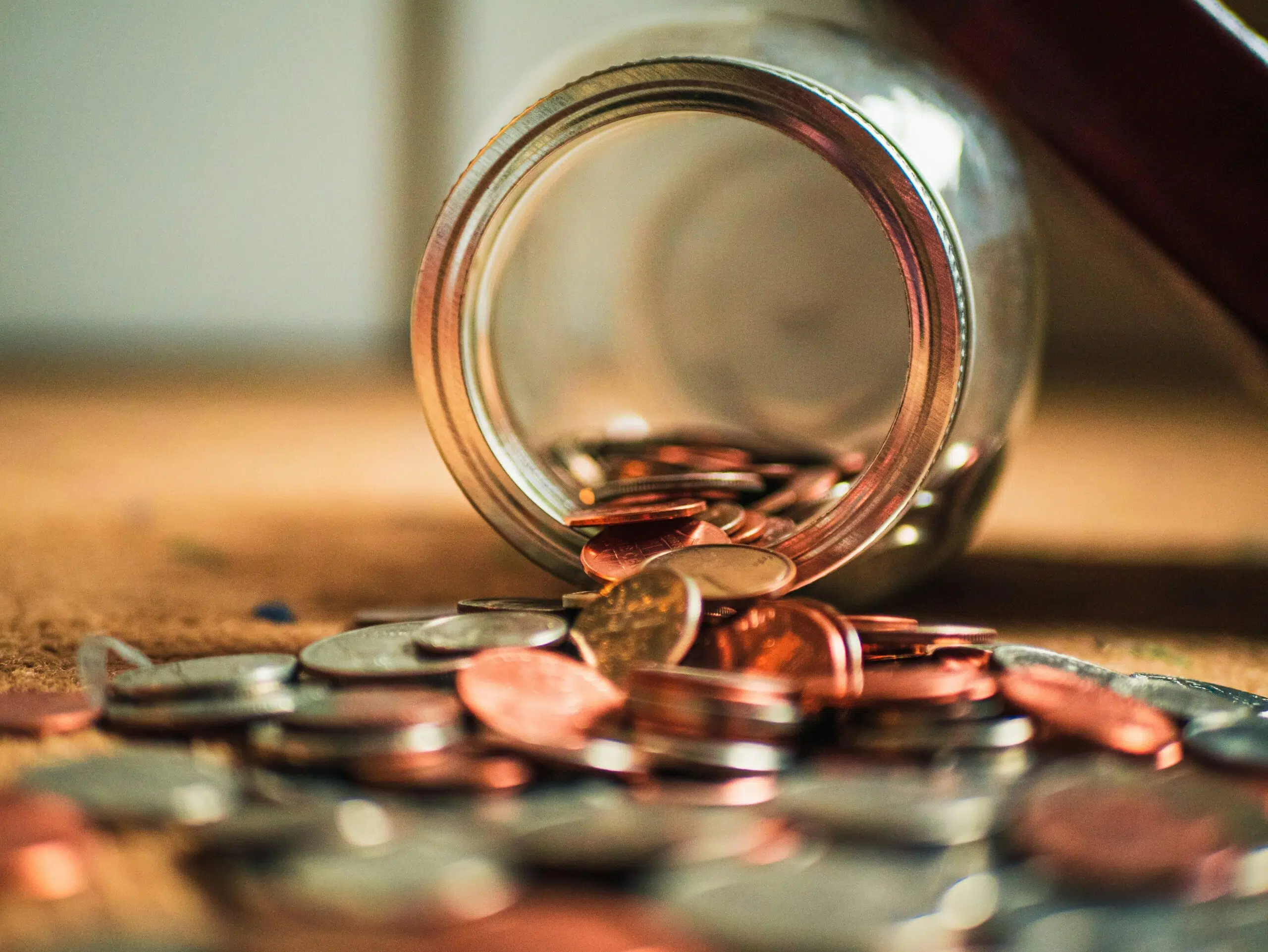 a jar spilling coins