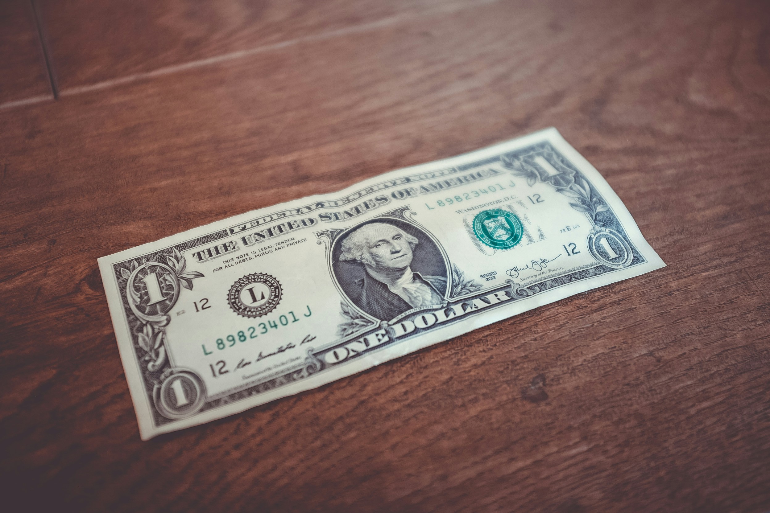 a dollar bill on a desk | Cohesion a dollar bill on a desk