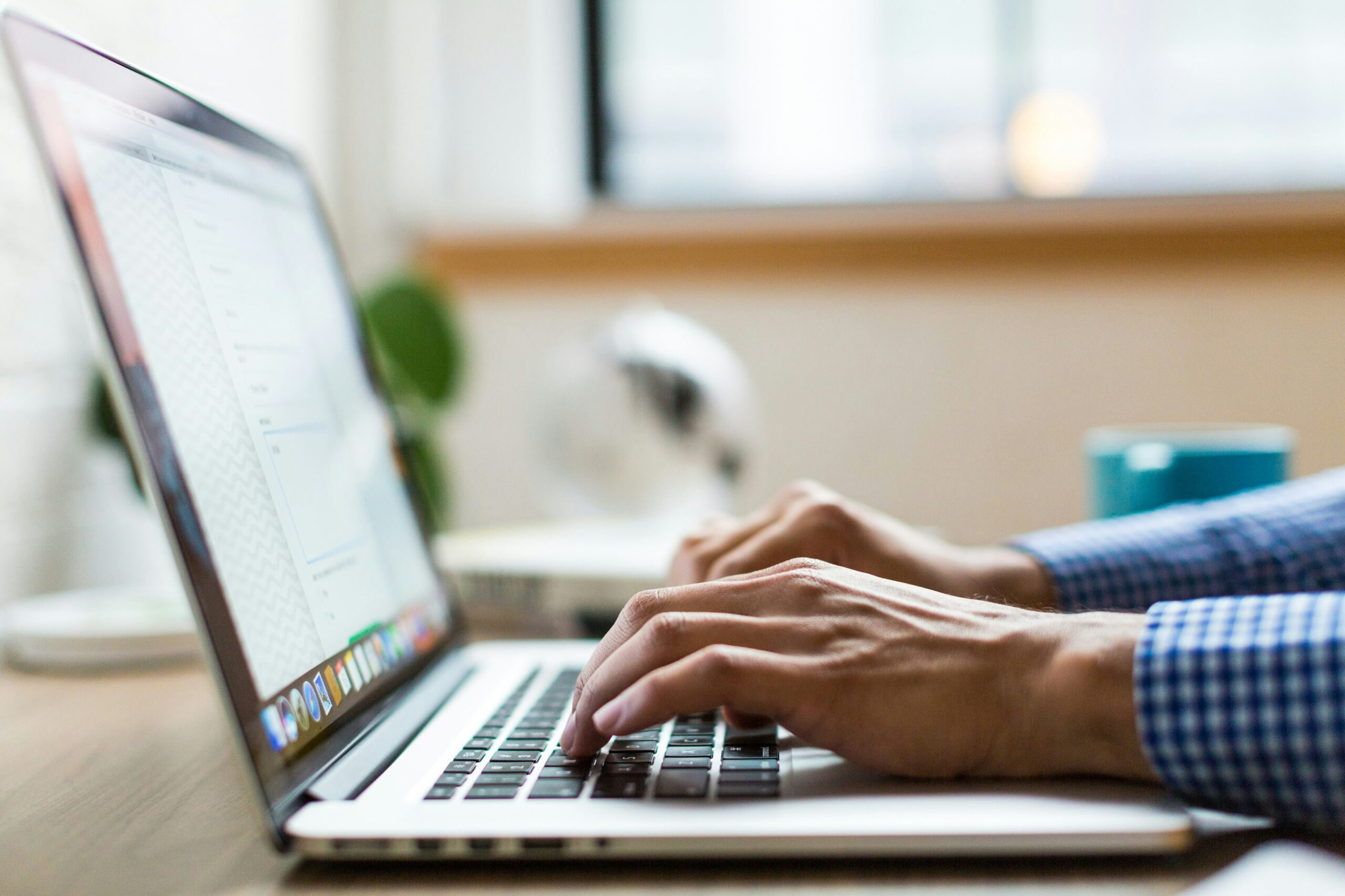 a person typing on laptop | Cohesion a person typing on laptop