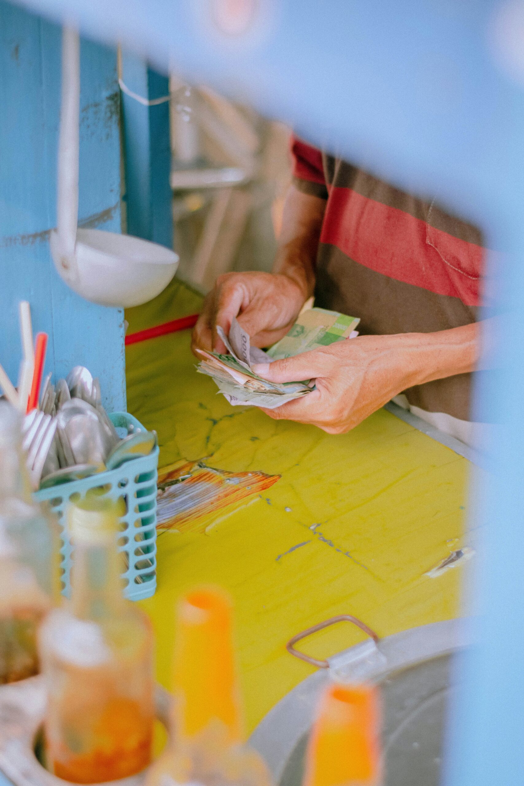 a person counting money | Cohesion a person counting money