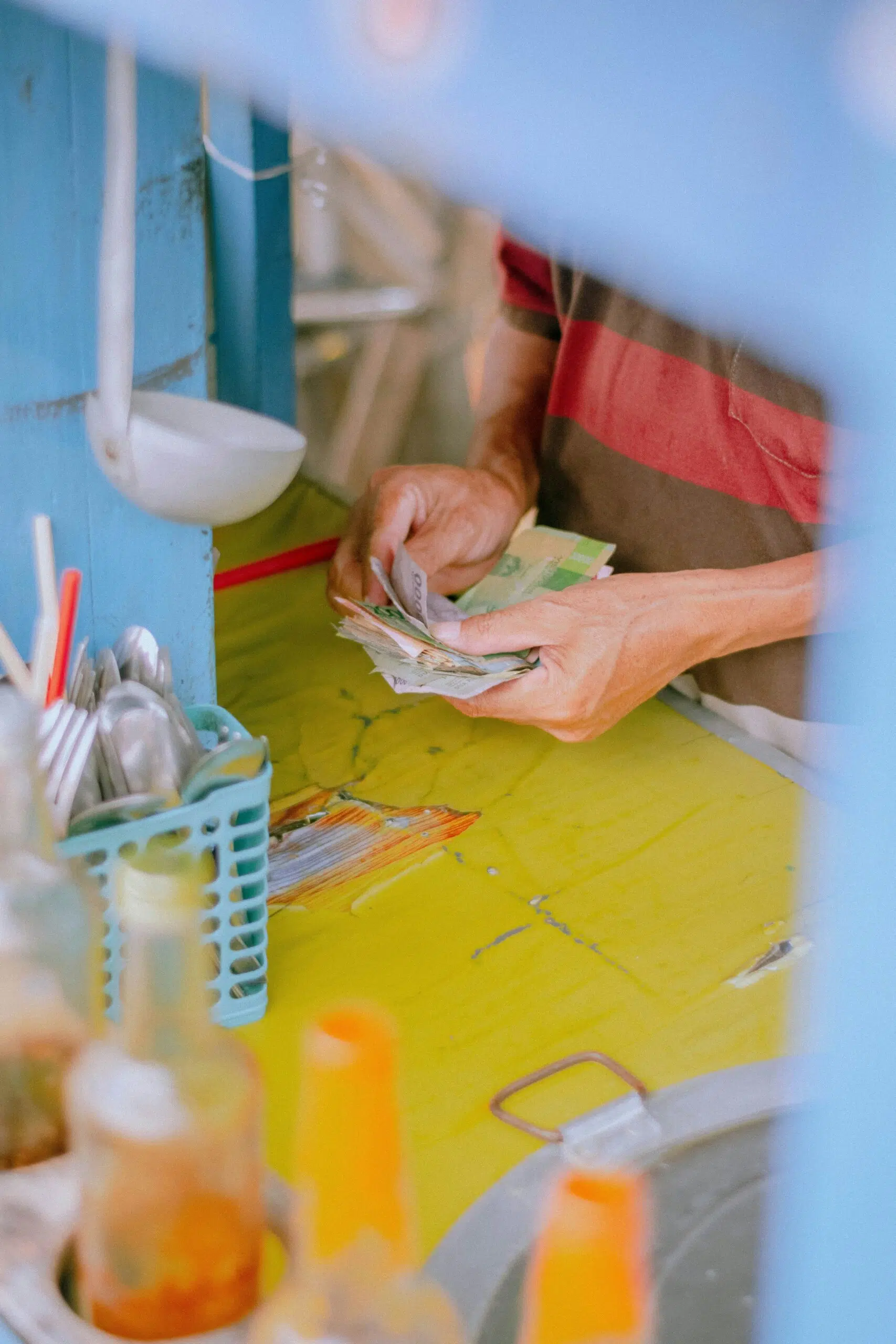 a person counting money | Cohesion a person counting money