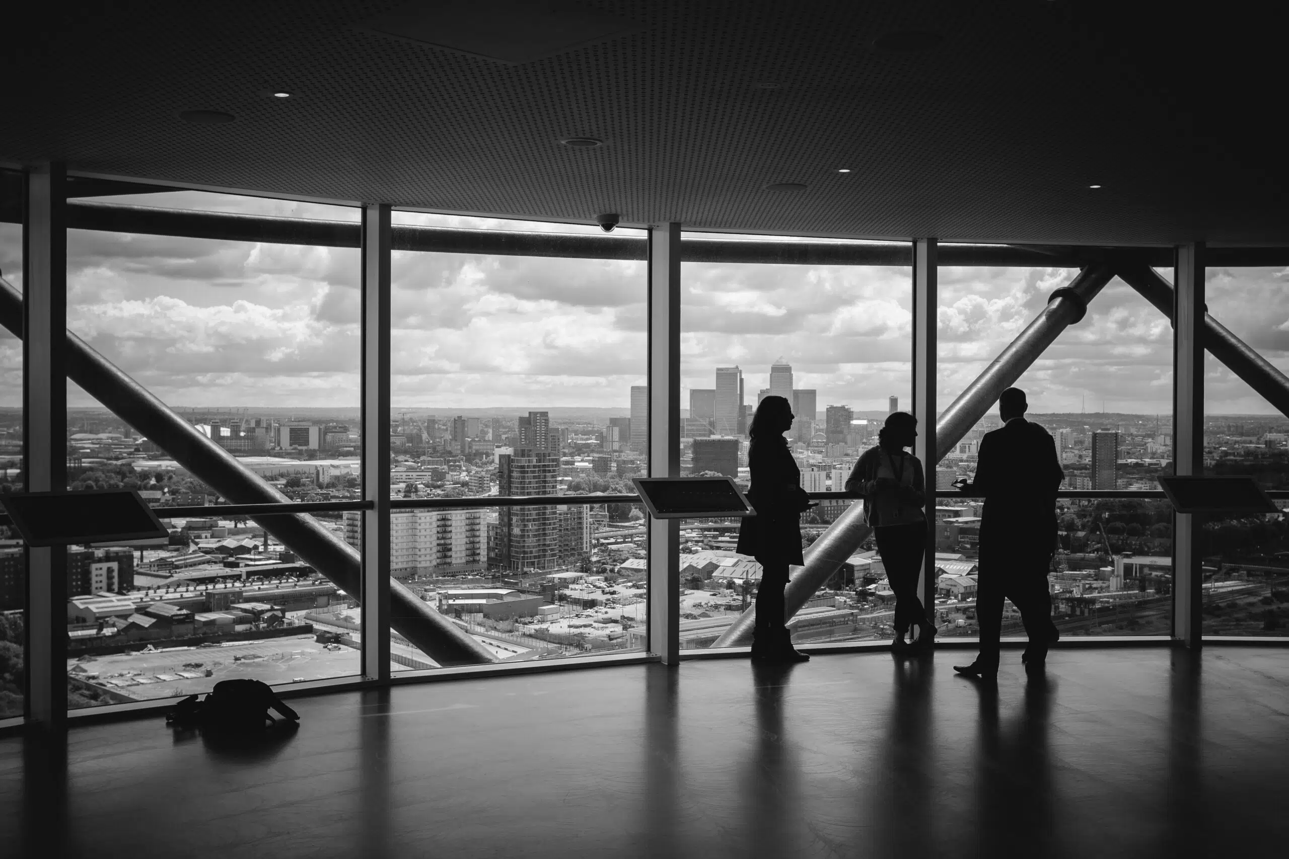 business people looking out from a building | Cohesion business people looking out from a building
