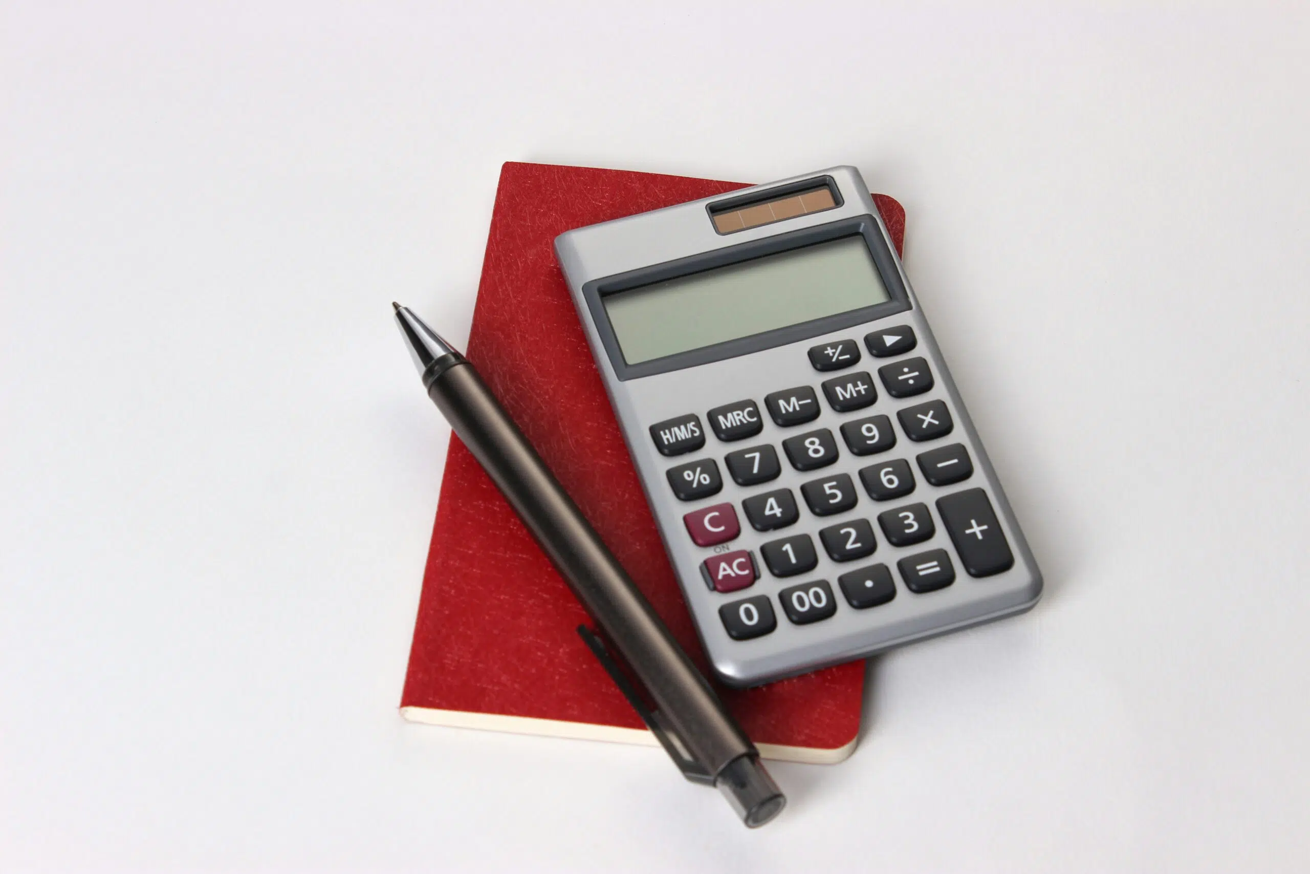 calculator with notebook and pen
